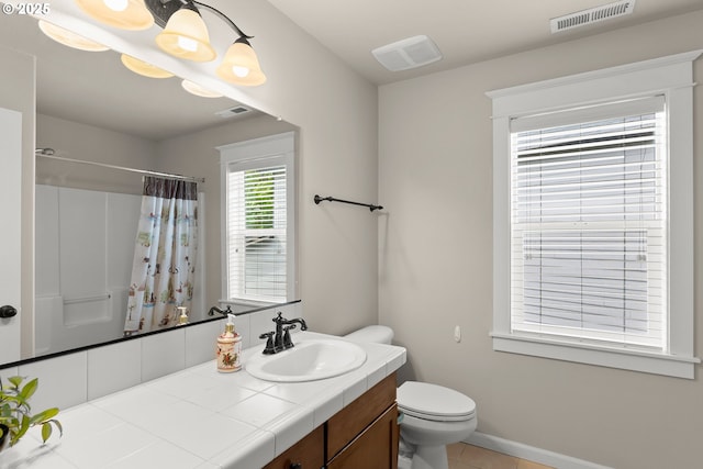 bathroom with vanity, tile patterned flooring, toilet, and visible vents