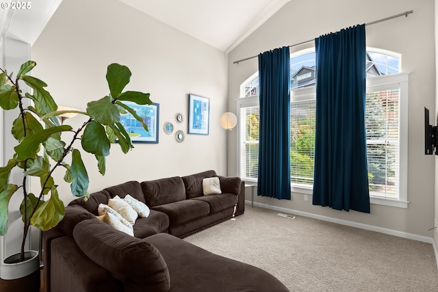living room featuring a healthy amount of sunlight, baseboards, carpet flooring, and lofted ceiling