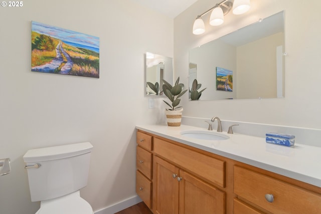 bathroom with toilet and vanity