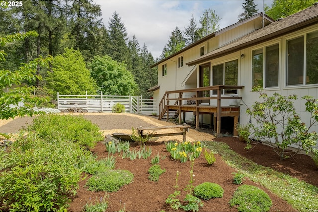 view of yard with a deck and fence
