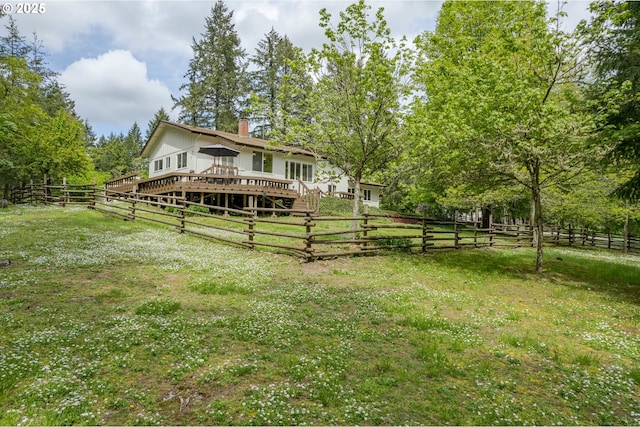 view of yard with fence and a wooden deck