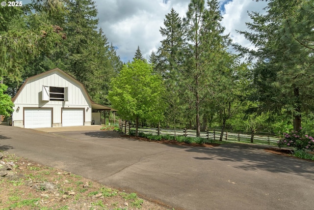 garage featuring fence and a garage