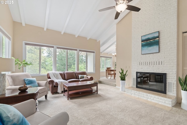 carpeted living area with ceiling fan, beam ceiling, a brick fireplace, high vaulted ceiling, and visible vents