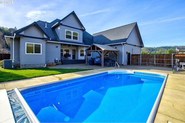 459 Oak Valley Loop, Winchester, OR 97495 - rear view of property featuring a patio, a gazebo, a fenced backyard, and roof with shingles