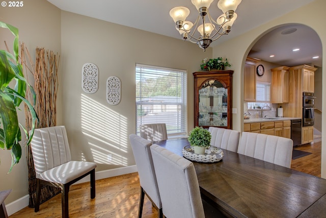 459 Oak Valley Loop, Winchester, OR 97495 - dining space featuring a chandelier, arched walkways, light wood-style flooring, and recessed lighting