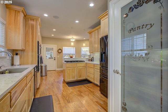 459 Oak Valley Loop, Winchester, OR 97495 - kitchen featuring light brown cabinets, a peninsula, fridge with ice dispenser, decorative backsplash, and recessed lighting