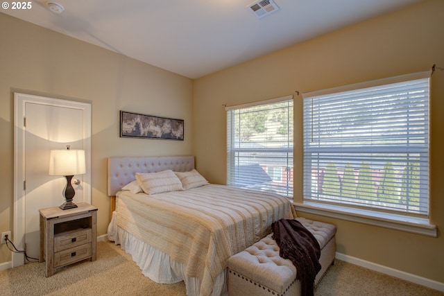 bedroom featuring light carpet