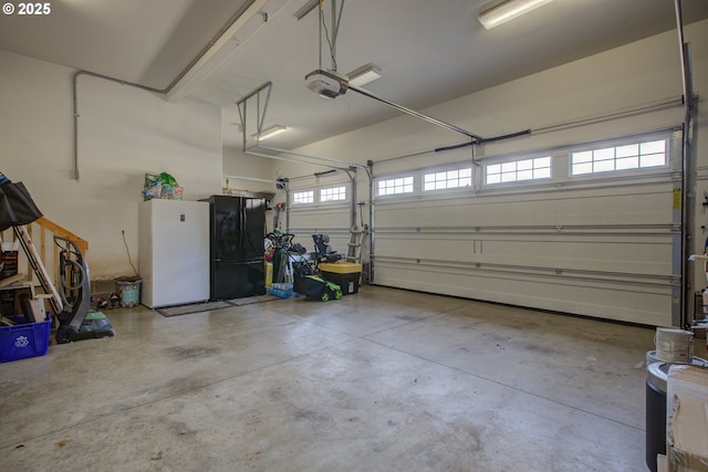 459 Oak Valley Loop, Winchester, OR 97495 - garage featuring a garage door opener and freestanding refrigerator