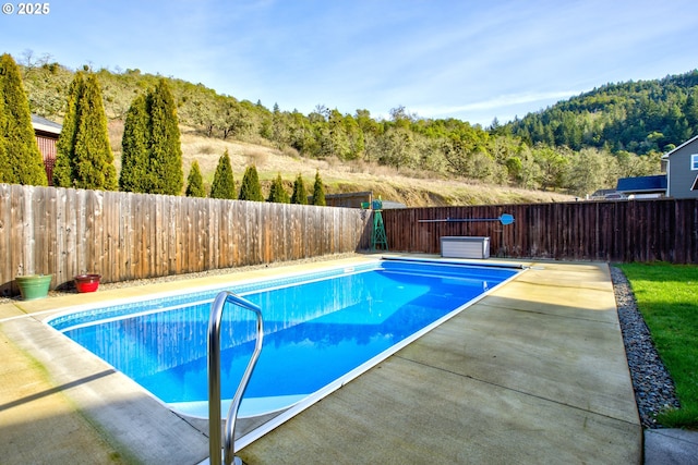 459 Oak Valley Loop, Winchester, OR 97495 - view of swimming pool featuring a patio area, a fenced backyard, and a view of trees
