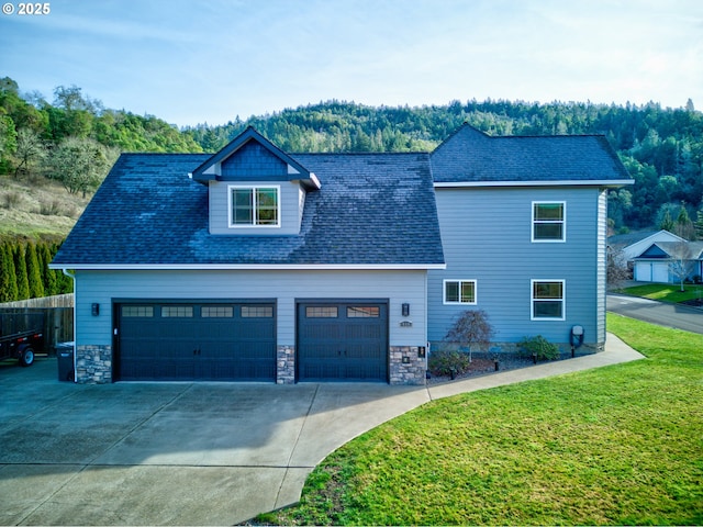 459 Oak Valley Loop, Winchester, OR 97495 - view of front of home with driveway, an attached garage, and stone siding