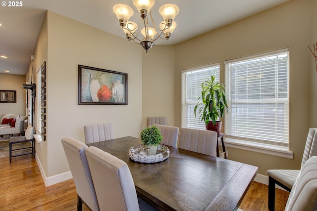 dining room with a notable chandelier and hardwood / wood-style flooring