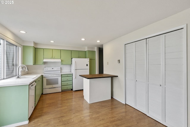 6125 SW Erickson Ave, Beaverton, OR 97008 - kitchen with green cabinets, white appliances, a sink, under cabinet range hood, and recessed lighting