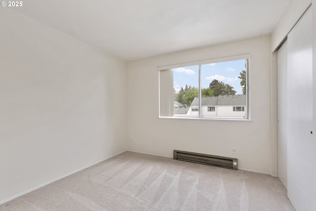 6125 SW Erickson Ave, Beaverton, OR 97008 - carpeted empty room featuring a baseboard heating unit and baseboards