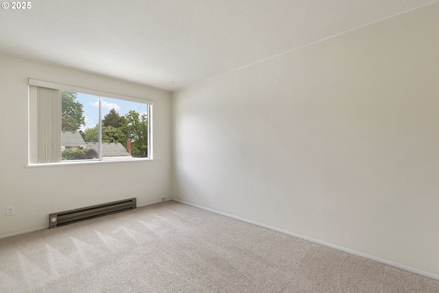 6125 SW Erickson Ave, Beaverton, OR 97008 - empty room with a baseboard heating unit, carpet flooring, and baseboards