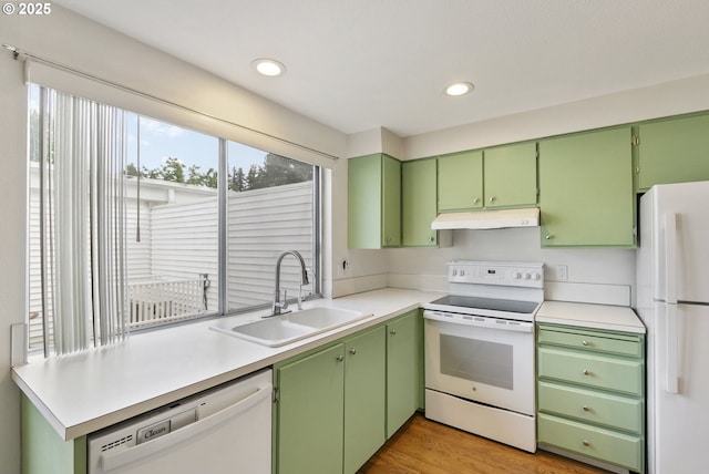 6125 SW Erickson Ave, Beaverton, OR 97008 - kitchen featuring white appliances, a sink, under cabinet range hood, recessed lighting, and light countertops