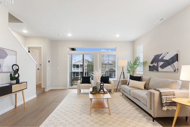 living room featuring a wealth of natural light and light wood-type flooring