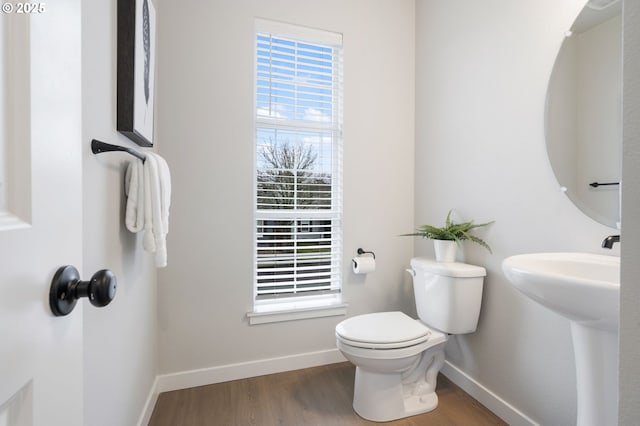 bathroom featuring hardwood / wood-style flooring, toilet, and sink