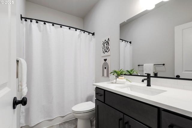 full bathroom with shower / bathtub combination with curtain, vanity, and toilet