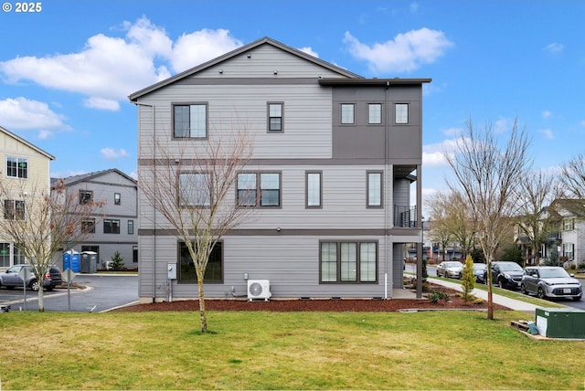 rear view of property featuring a yard