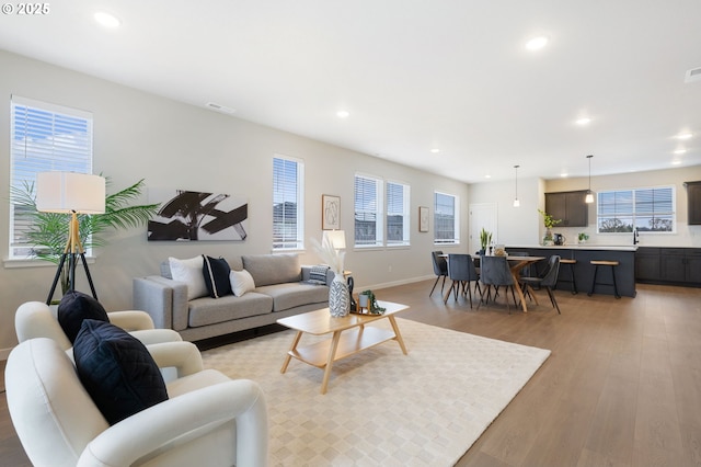 living room with sink and light wood-type flooring