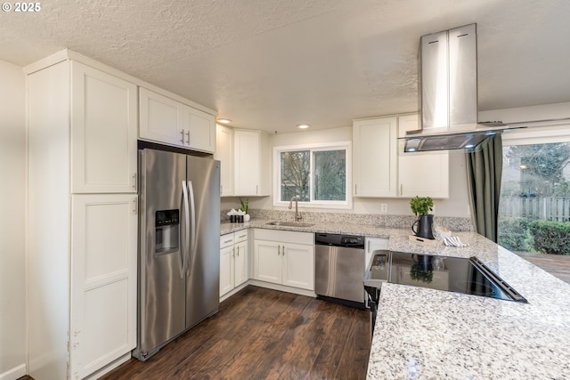 kitchen with sink, island range hood, stainless steel appliances, and white cabinetry