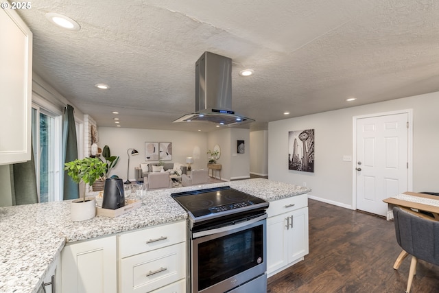 kitchen featuring light stone countertops, white cabinetry, island range hood, and stainless steel electric range