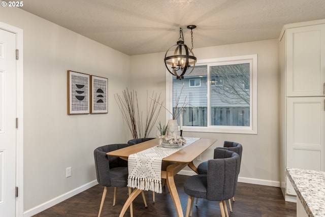 dining room featuring dark wood-type flooring and an inviting chandelier