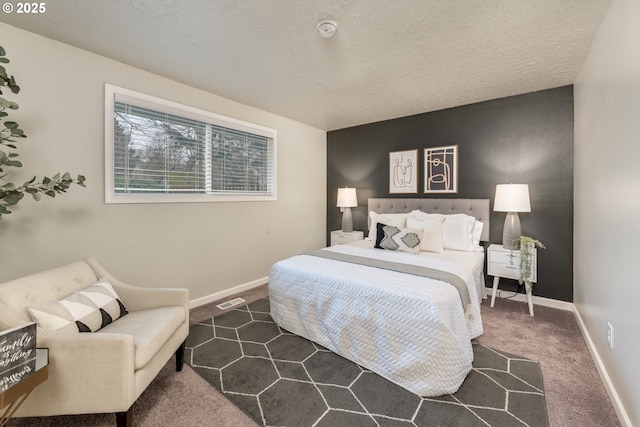 carpeted bedroom featuring a textured ceiling