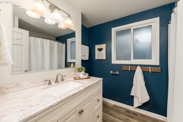 bathroom featuring vanity and hardwood / wood-style floors