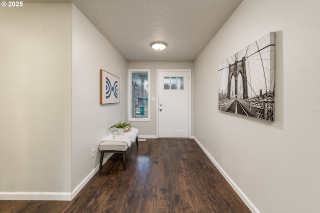 entryway with a textured ceiling and dark hardwood / wood-style floors