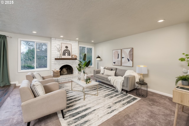 carpeted living room featuring a fireplace and a textured ceiling