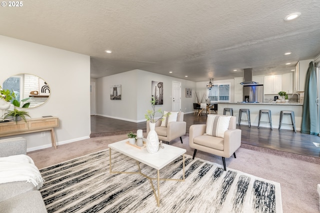 living room with light carpet and a textured ceiling