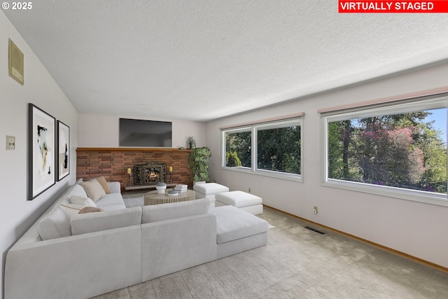 living area featuring a brick fireplace, carpet flooring, baseboards, and a textured ceiling