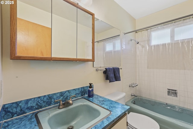 full bathroom featuring toilet, washtub / shower combination, and vanity