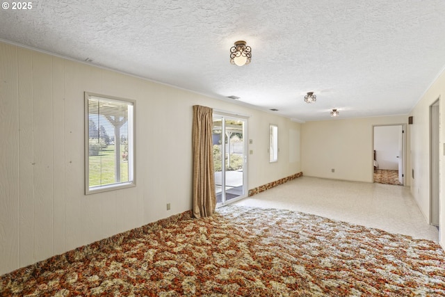 unfurnished bedroom with carpet, baseboards, and a textured ceiling