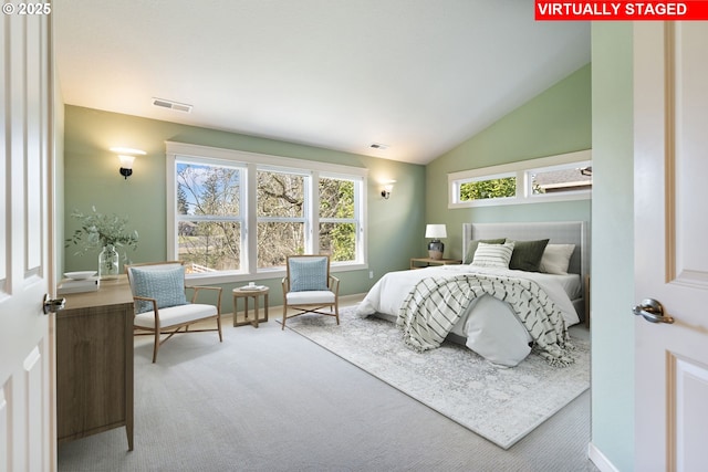 carpeted bedroom featuring lofted ceiling, visible vents, and baseboards