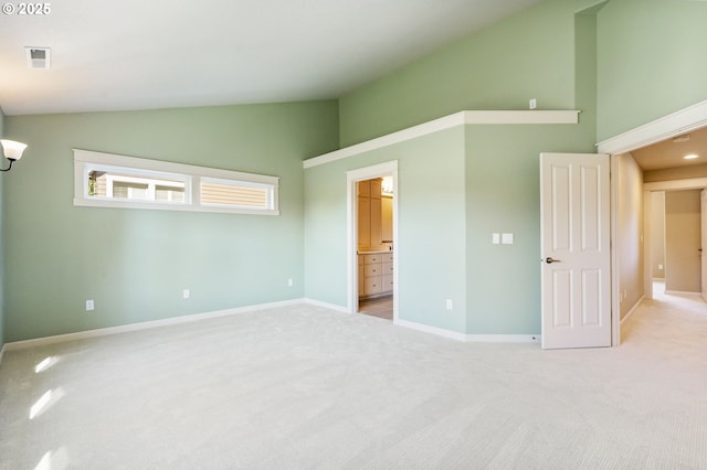 unfurnished bedroom featuring light carpet, visible vents, baseboards, connected bathroom, and high vaulted ceiling