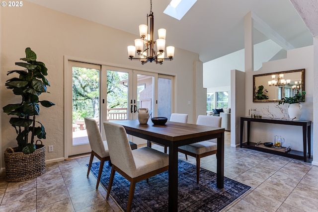 dining area featuring french doors, a skylight, baseboards, high vaulted ceiling, and a notable chandelier