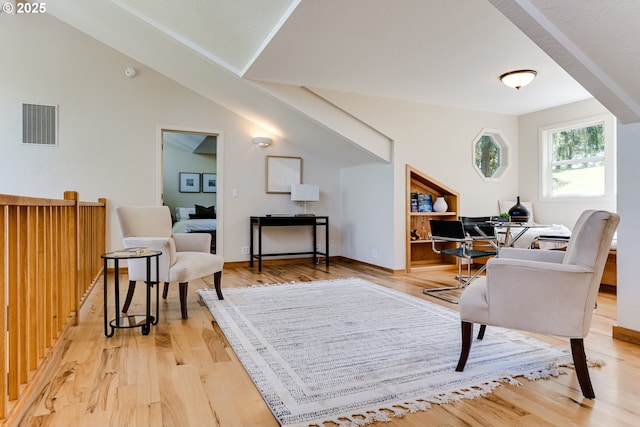living area featuring visible vents and light wood-style flooring