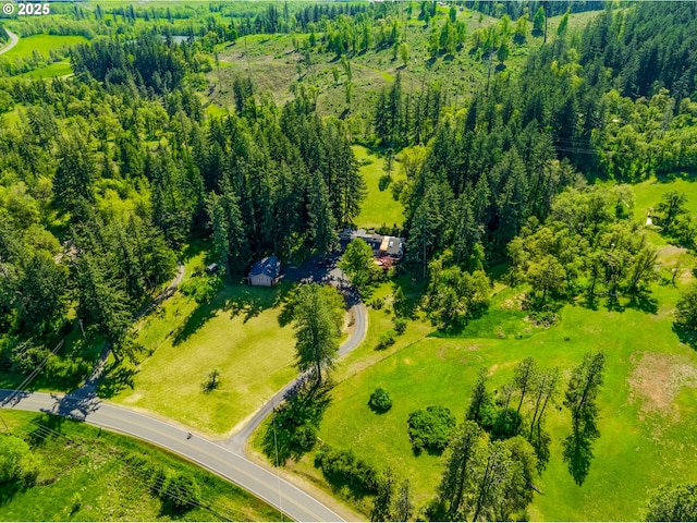 birds eye view of property with a forest view