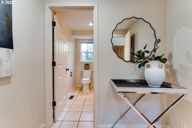 bathroom featuring vanity, toilet, tile patterned floors, baseboards, and visible vents