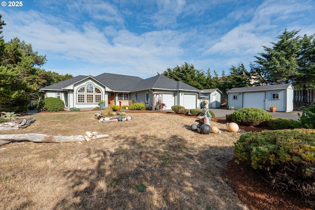 89523 Manion Dr, Warrenton, OR 97146 - ranch-style home featuring a garage, driveway, and an outbuilding