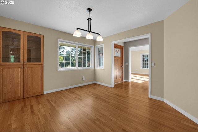 89523 Manion Dr, Warrenton, OR 97146 - unfurnished dining area with light wood-style floors and a chandelier