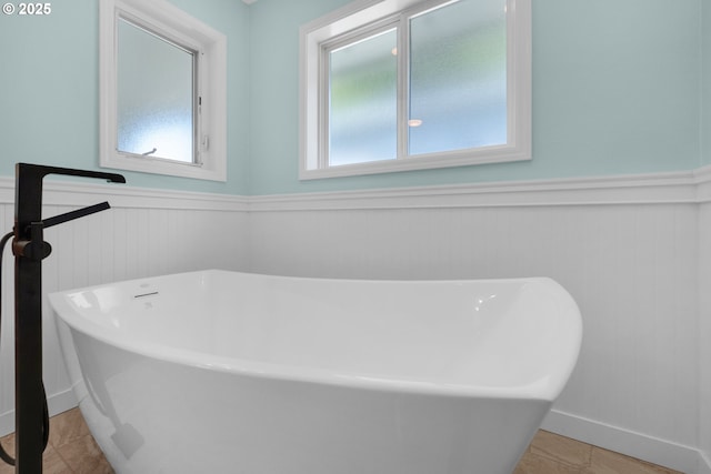 89523 Manion Dr, Warrenton, OR 97146 - bathroom featuring wainscoting, a freestanding bath, and tile patterned flooring