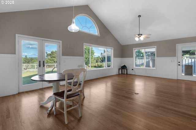 89523 Manion Dr, Warrenton, OR 97146 - dining room with wainscoting, french doors, ceiling fan, wood finished floors, and high vaulted ceiling