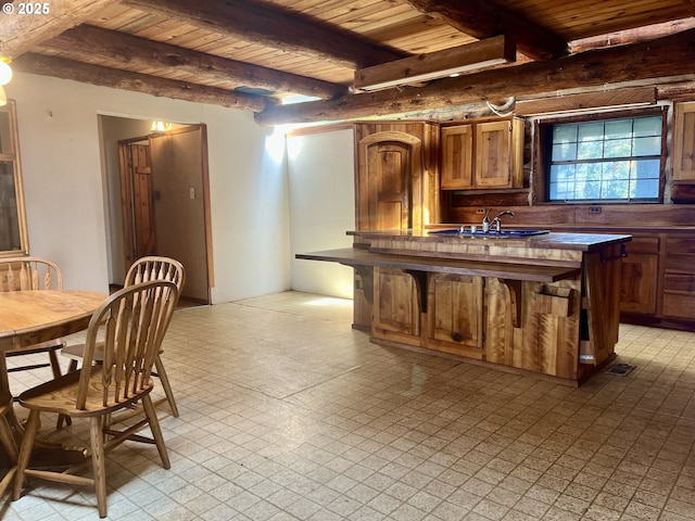29202 Wallace St, Gold Beach, OR 97444 - kitchen with dark countertops, wooden ceiling, a sink, and light floors