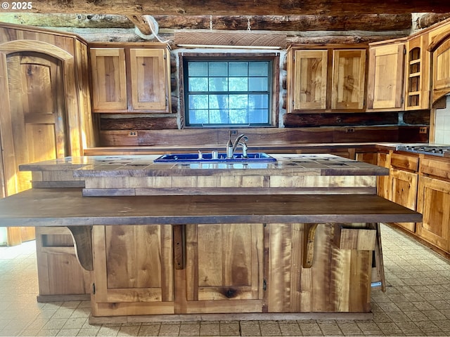 29202 Wallace St, Gold Beach, OR 97444 - kitchen featuring open shelves, a sink, light floors, and dark countertops