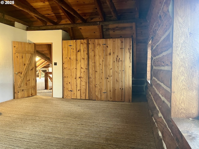 29202 Wallace St, Gold Beach, OR 97444 - carpeted empty room featuring wooden walls, beamed ceiling, and wooden ceiling