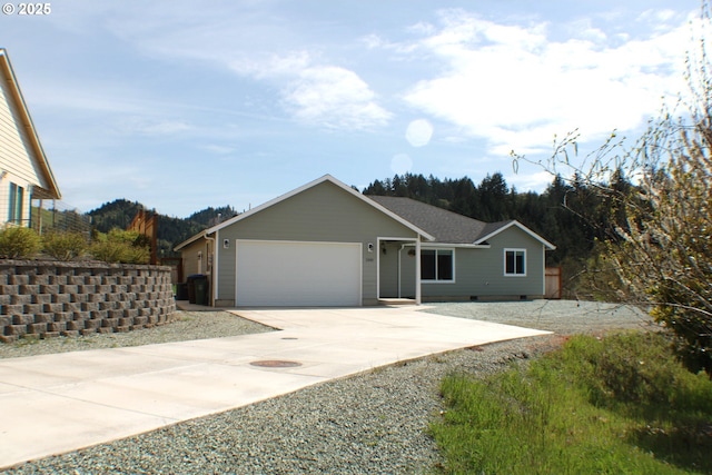 ranch-style house featuring a garage and concrete driveway
