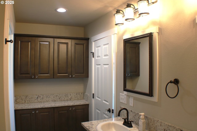 bathroom with recessed lighting and vanity
